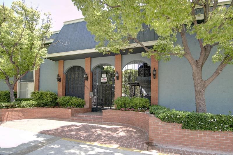 A Building With a Gate and Trees